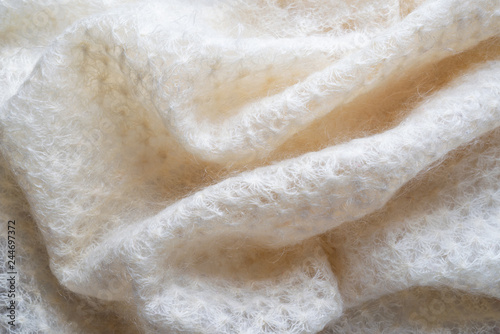 Soft folds of a white goat fluff scarf to be used as background