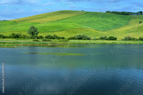 Beautiful green hill and blue lake water