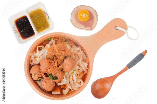 Delicious homemade Bakso, famous traditional Indonesian street food, meatballs with noodles served with chili saucel and soy sauce isolated on white background photo