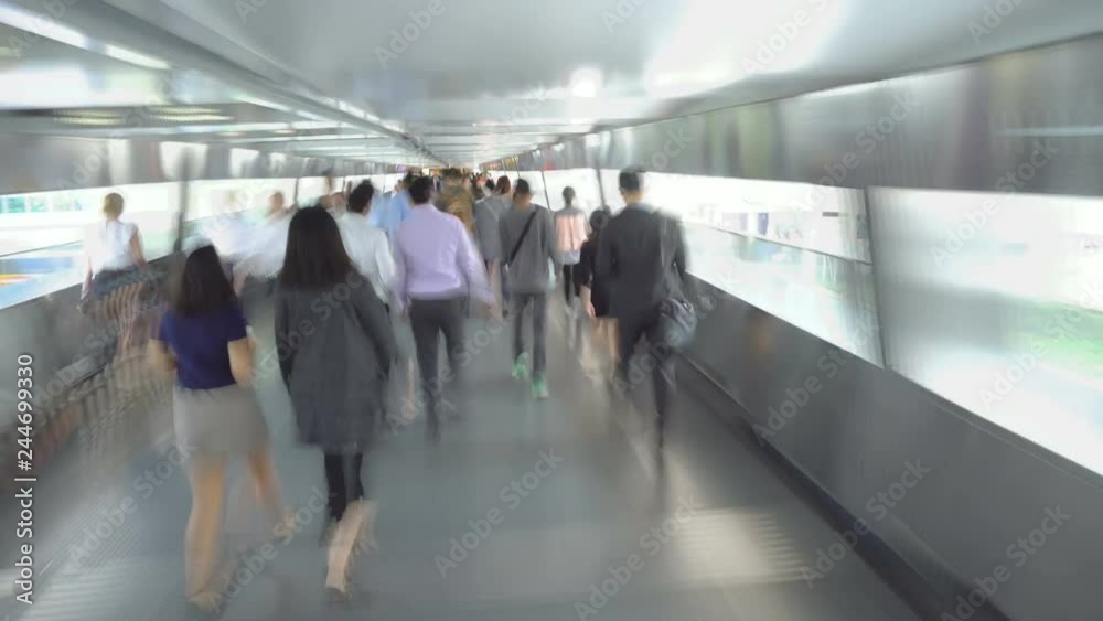 Anonymous Crowds of Asian People Walking on Elevated Walkway in City Anonymous Crowds of Asian People Walking on Elevated Walkway in City