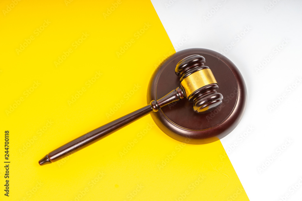 Gavel hammer with yellow background Gavel hammer with yellow background