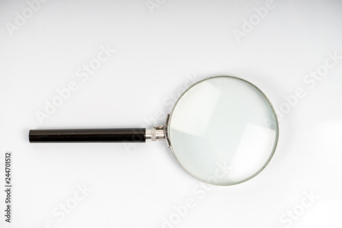 Magnifier glass on the white background