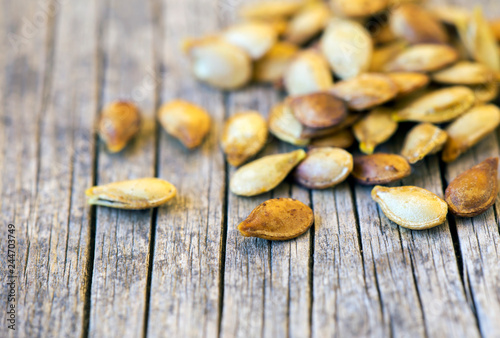 Healthy eating - close-up of roasted yellow pumpkin seeds, vegetarian snack