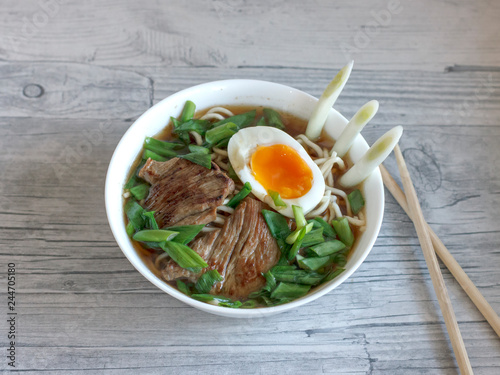 Ramen soup with fresh onions, boiled egg and fried meat