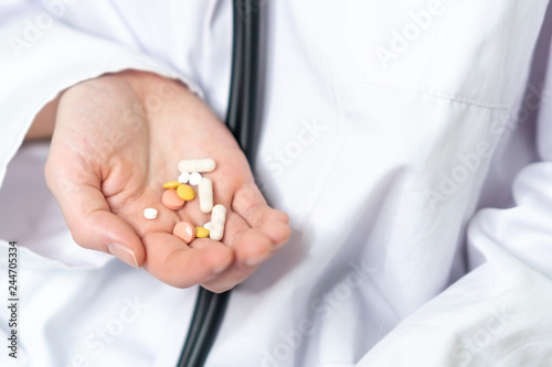 Female doctor hand holding pills