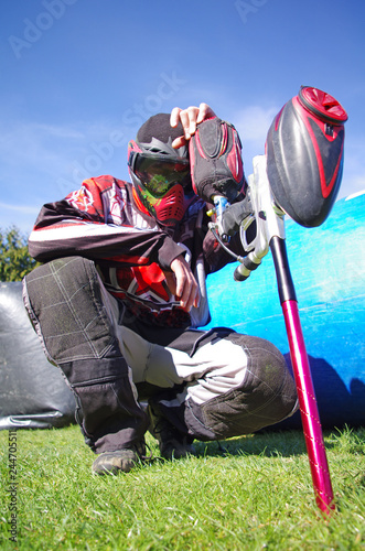 Paintball sport player with splatter on his mask