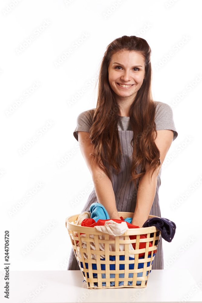 woman doing a housework holding laundry isolated over white background woman doing a housework holding laundry isolated over white background