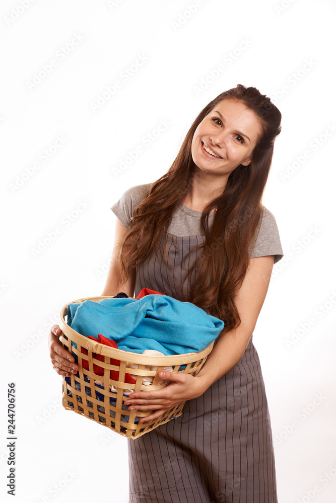 woman doing a housework holding laundry isolated over white background woman doing a housework holding laundry isolated over white background