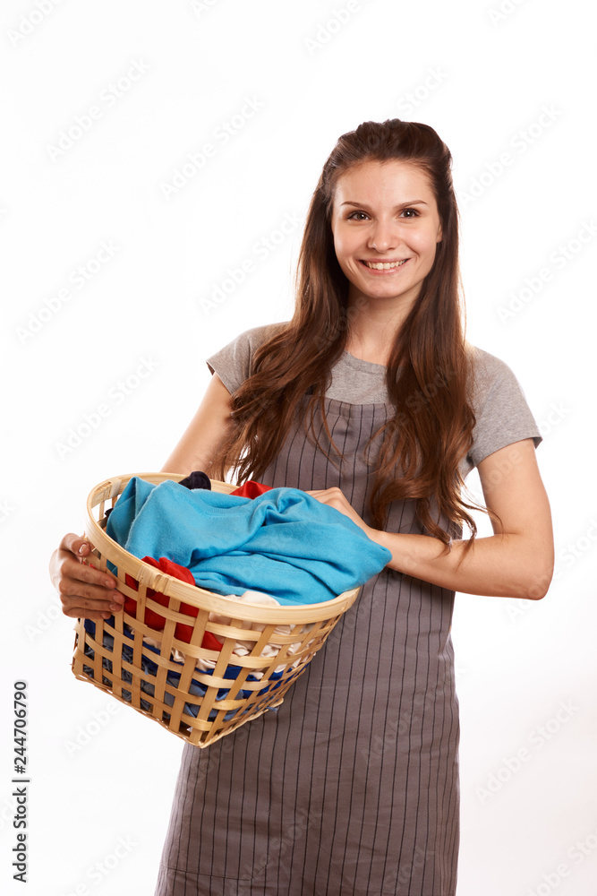 woman doing a housework holding laundry isolated over white background woman doing a housework holding laundry isolated over white background