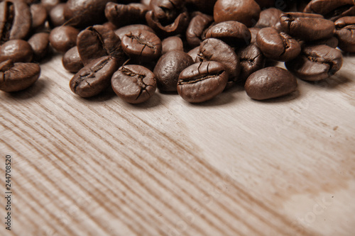 Coffee beans on wooden texture background. Drink, cheerfulness, pleasure concept.