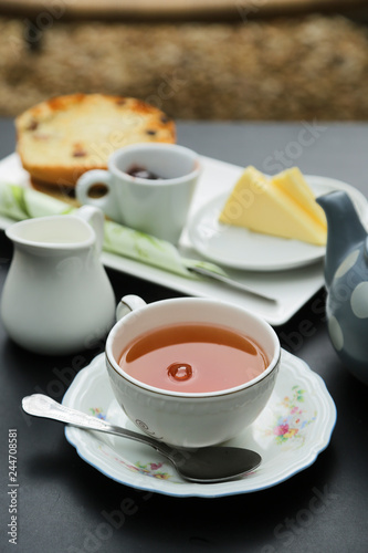 Tea served with cream, butter and a cake © marysckin