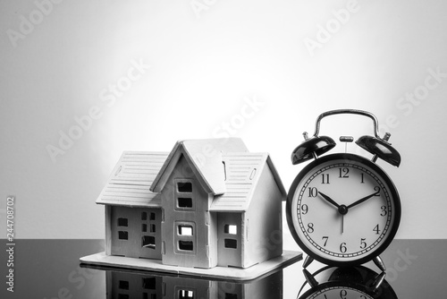 Clock and house with yellow background