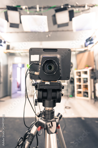 Film camera in broadcasting studio  spotlights and other equipment