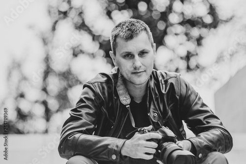 30 years old photographer with camera, black and white, noise photo