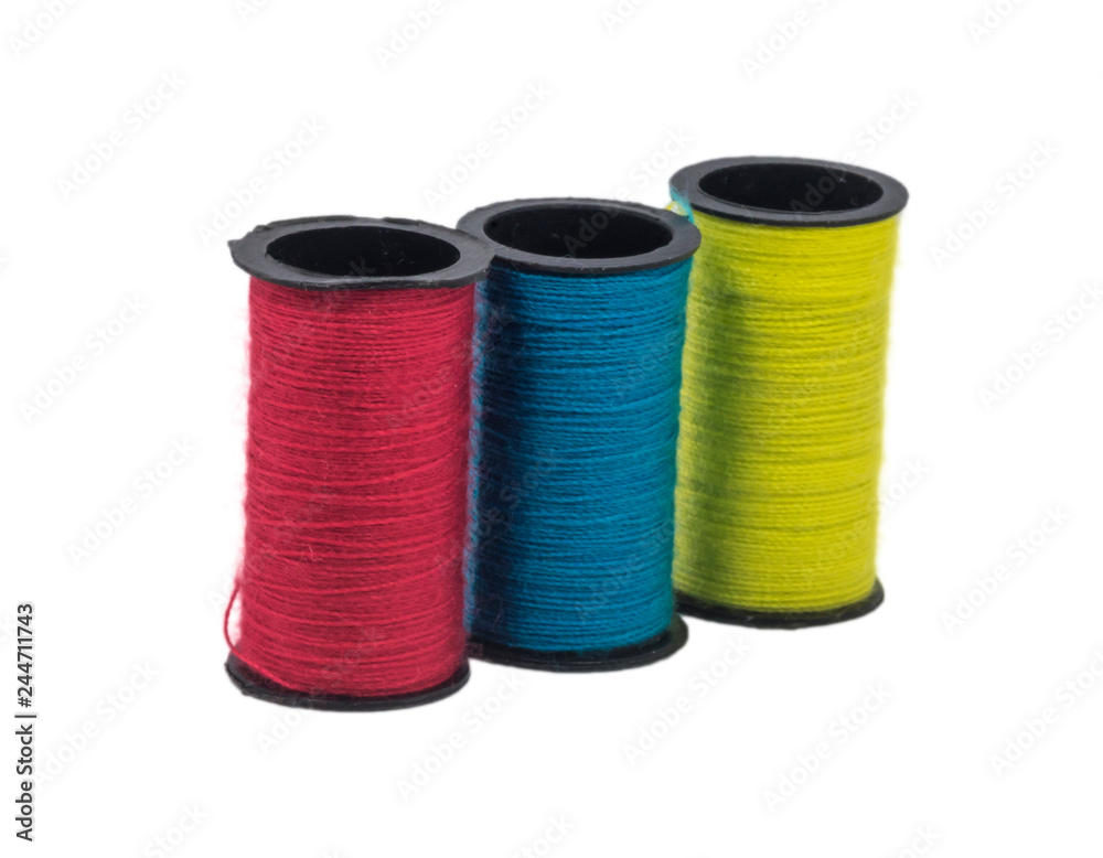 Multicolor sewing threads with isolated white background Multicolor sewing threads with isolated white background