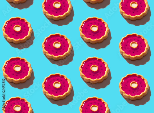 cookies with red jam on the background of the texture of fashionable pastel blue paper in a minimal concept. minimum pattern