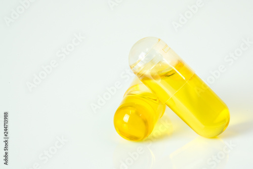 Olive capsule with white background.