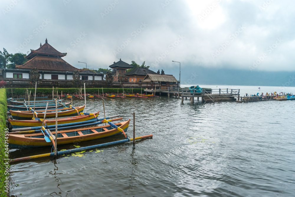 Traditional wooden boat with cloudy skies.