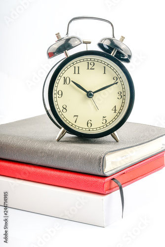 Clock and book with white background.