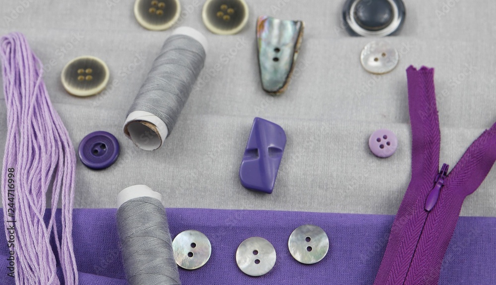 Combination of the colors at design of clothes, gray cotton fabric with violet one. Assortment of the accessories for sewing and needlework Combination of the colors at design of clothes, gray cotton fabric with violet one. Assortment of the accessories for sewing and needlework