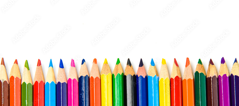 Colored pencils set lined with fence closeup on white background. Colored pencils set lined with fence closeup on white background.