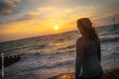 woman at sunrise on the beach © Daniel