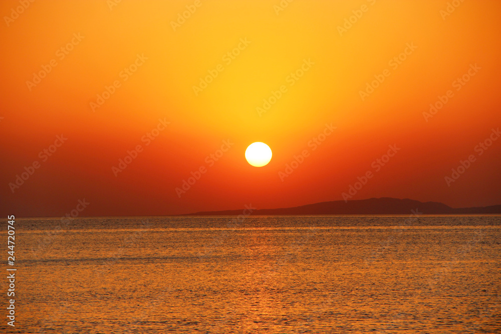 bright sunset above sea. Beautiful red summer decline above ocean