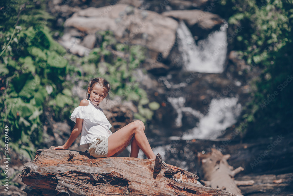 Little girl enjoying view of waterfall in Krasnay Poliana Little girl enjoying view of waterfall in Krasnay Poliana
