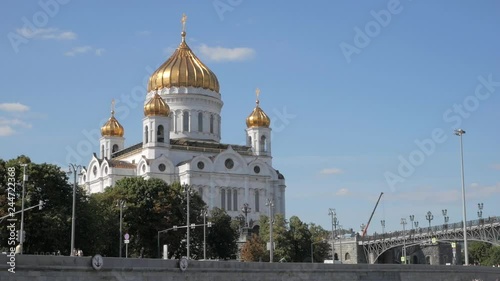 Monumental white Christ the Saviour Cathedral with golden domes on embankment of Moskva river in Russia