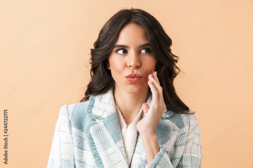Beautiful shocked brunette woman dressed in plaid jacket
