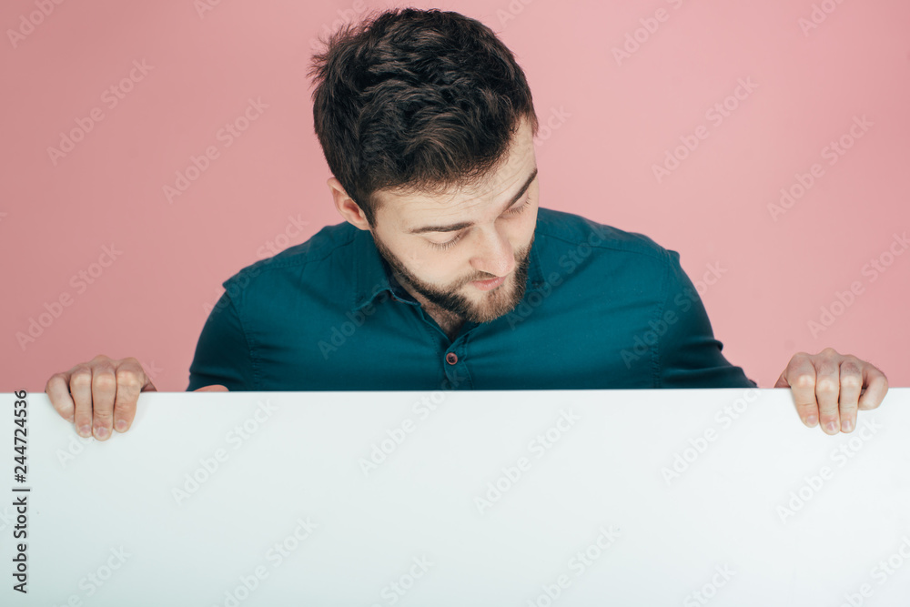 young man cheerful and motivated, showing an empty poster where you can show a message, communication concept young man cheerful and motivated, showing an empty poster where you can show a message, communication concept