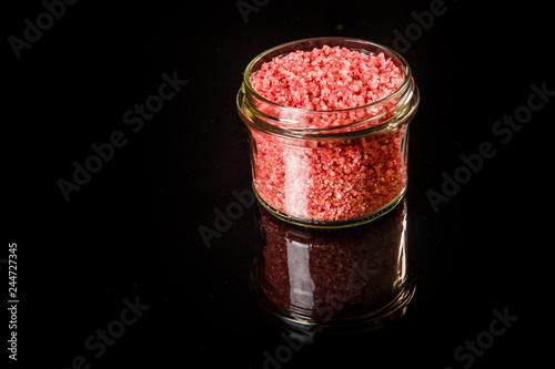 top view small glass jar with pink organic sea salt