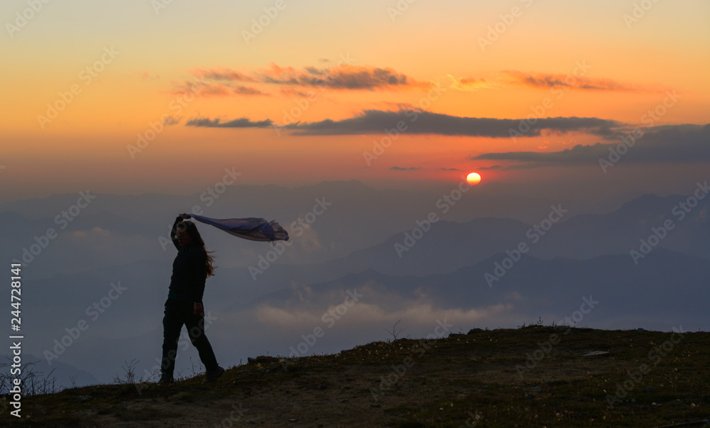 A young woman standing on mountain