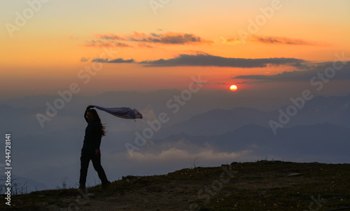 A young woman standing on mountain