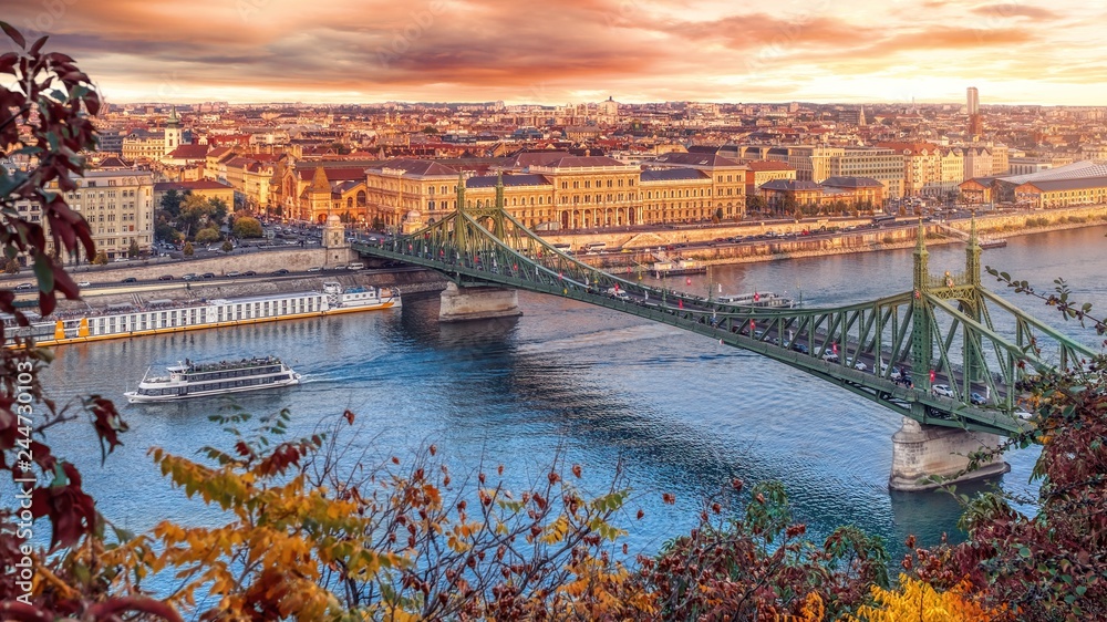 Aerial panorama of Budapest, Hungary. Sunset over the city with the Liberty Bridge, the Danube river.