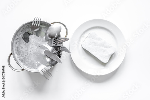 concept of washing dishes on white background top view photo