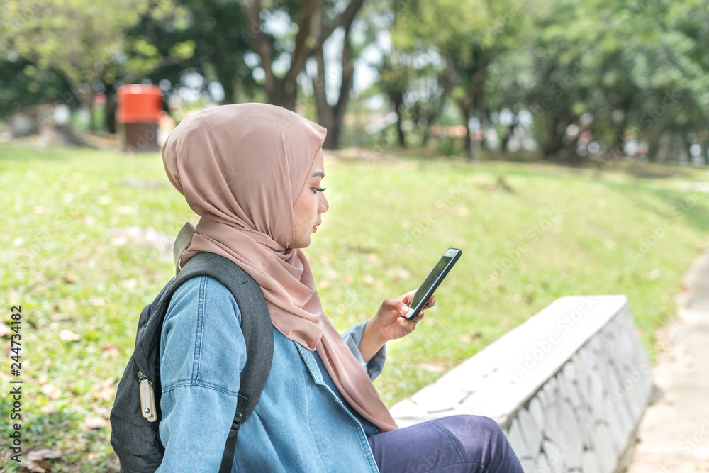 Fototapeta premium Veiled teenager at outdoor park.