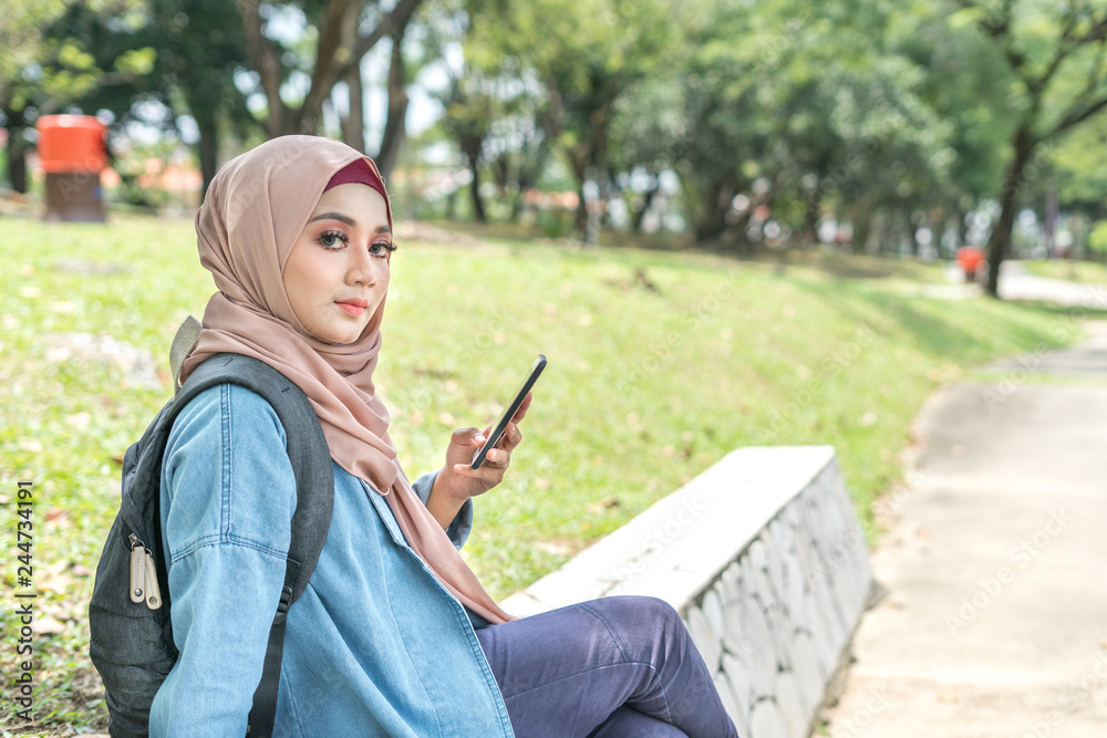 Fototapeta premium Veiled teenager at outdoor park.
