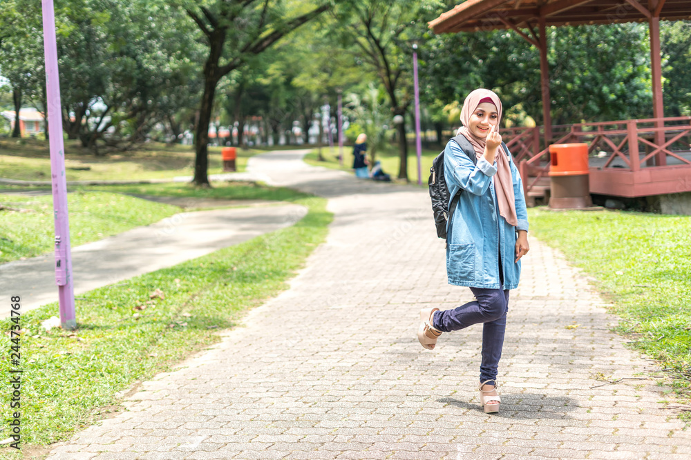 Fototapeta premium Veiled teenager at outdoor park.