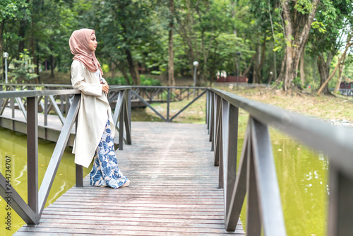 Veiled teenager at outdoor park. © mawardibahar