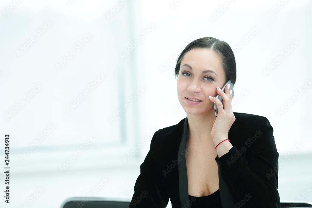 successful business woman talking on smartphone in her office successful business woman talking on smartphone in her office