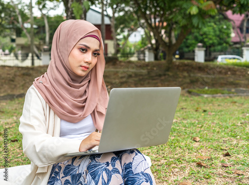 Veiled teenager at outdoor park.