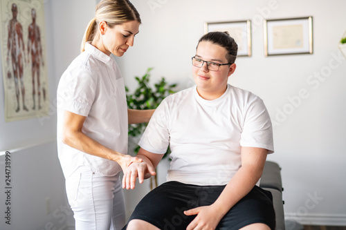 A Modern rehabilitation physiotherapy woman worker with client