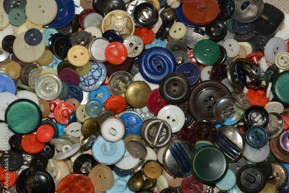 Scattered multicolored buttons on linen fabric Scattered multicolored buttons on linen fabric