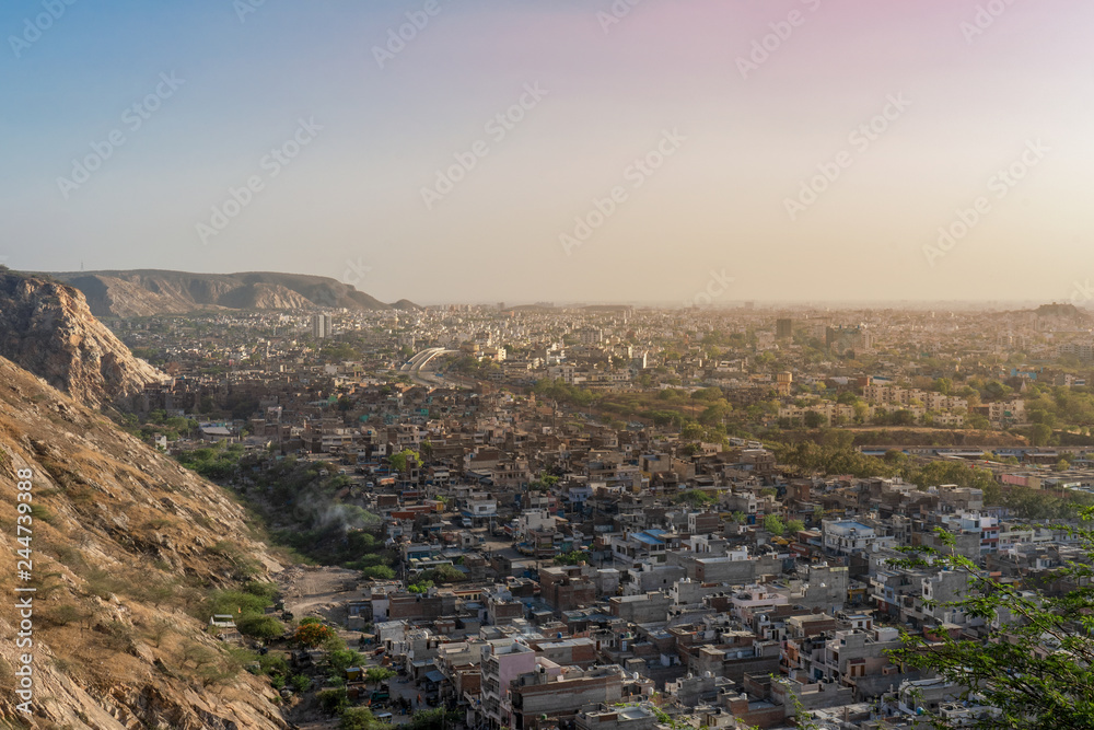 Obraz premium Aerial view of Jaipur cityscape from the sun temple view point near Galtaji Temple or the Monkey Palace in senset moment, Jaipur, Rajasthan, India