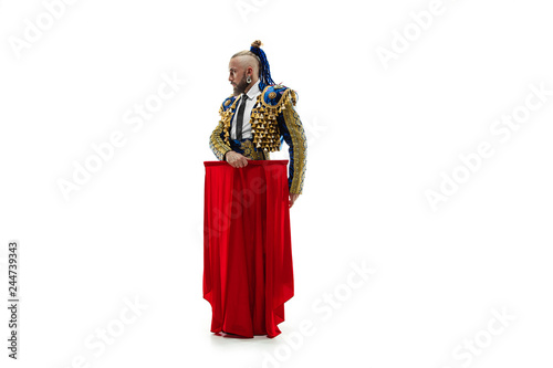 Torero in blue and gold suit or typical spanish bullfighter isolated over white studio background. The taming, achieving the goal, mortification, conquest, boss, leadership, battle, win, winner