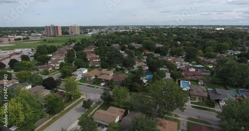 Flying To The Left Over Neighborhood And City In Distance photo