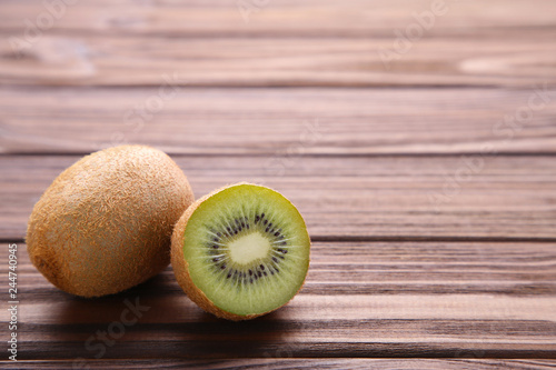Fresh kiwi fruit on brown wooden background