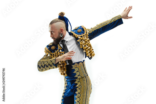 Torero in blue and gold suit or typical spanish bullfighter isolated over white studio background. The taming, achieving the goal, mortification, conquest, boss, leadership, battle, win, winner photo