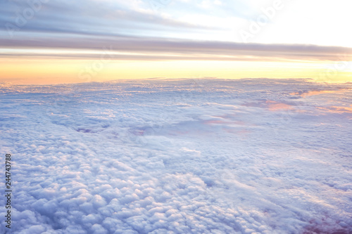 Sunny sky abstract background Beautiful cloudscape on the atmosphere heaven.Scenic view sunrise over white fluffy clouds from the airplane window.Freedom Nature Backdrop Concept.Copy space for text.